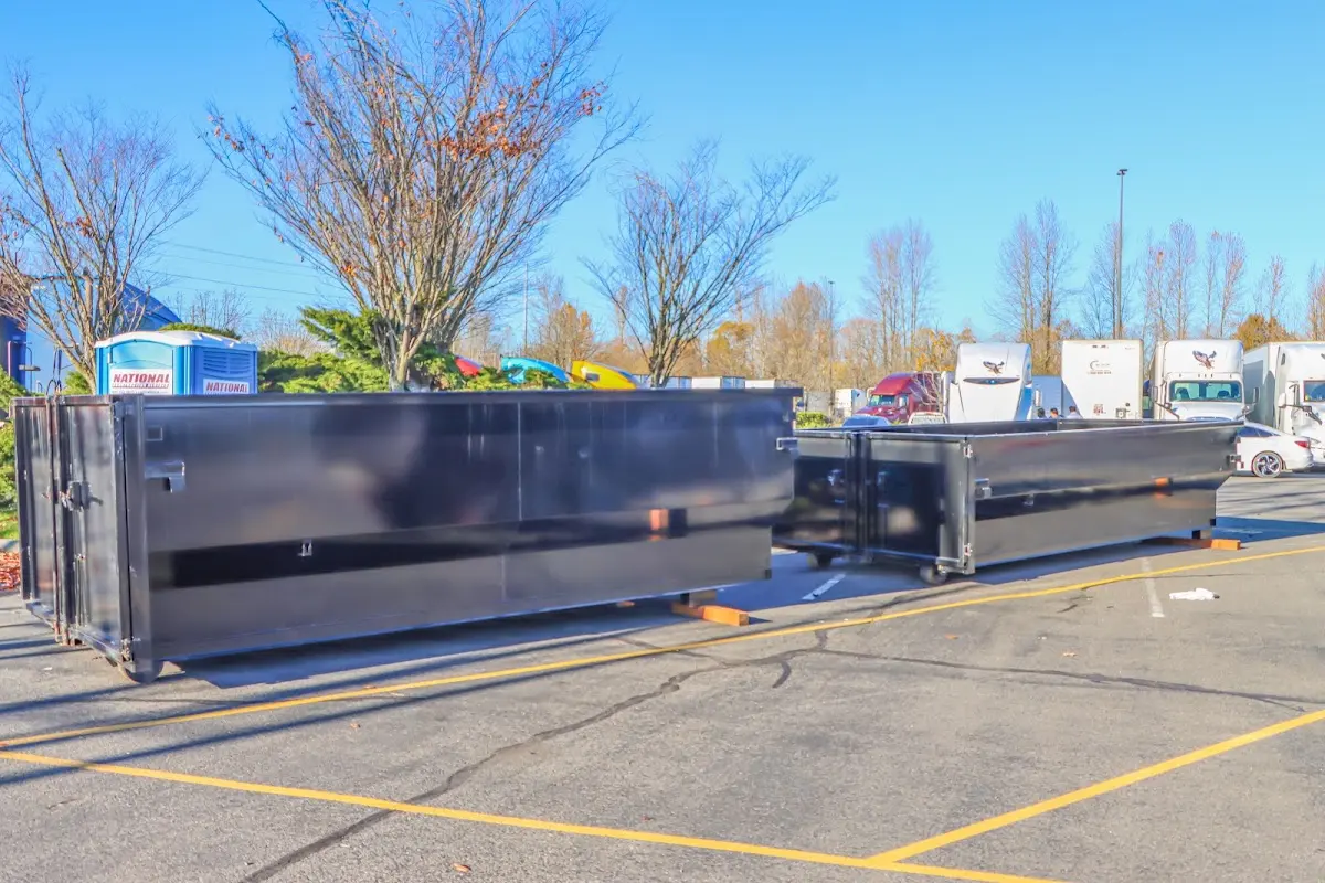 Professional dumpster rental service with roll-off container on residential driveway in Archbald